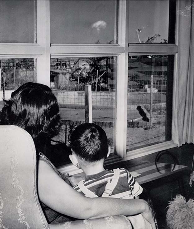 A mom and her son watch the mushroom cloud after an atomic test 75 miles away, Las Vegas, 1953