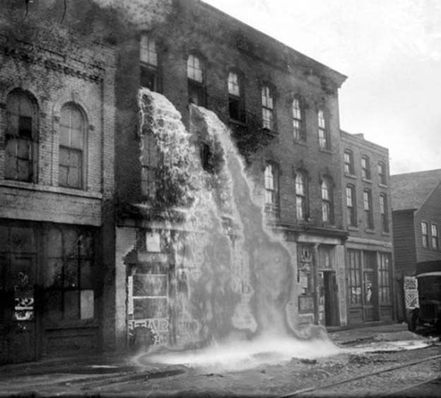 Illegal alcohol being poured out during Prohibition, Detroit 1929