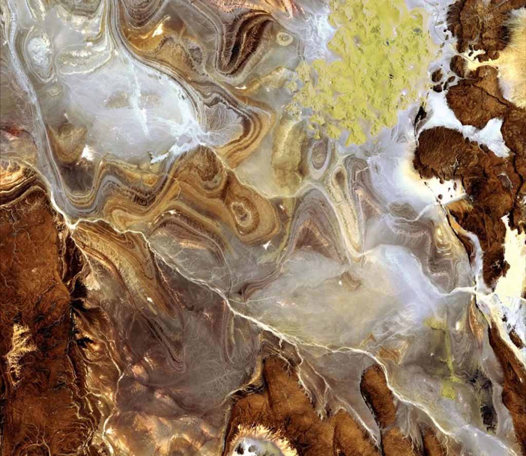 The image shows the extraordinary landscape of the Tanezrouft Basin, one of the most desolate parts of the Sahara desert, in south-central Algeria. The region is known as land of terrorâ because of its lack of water and vegetation