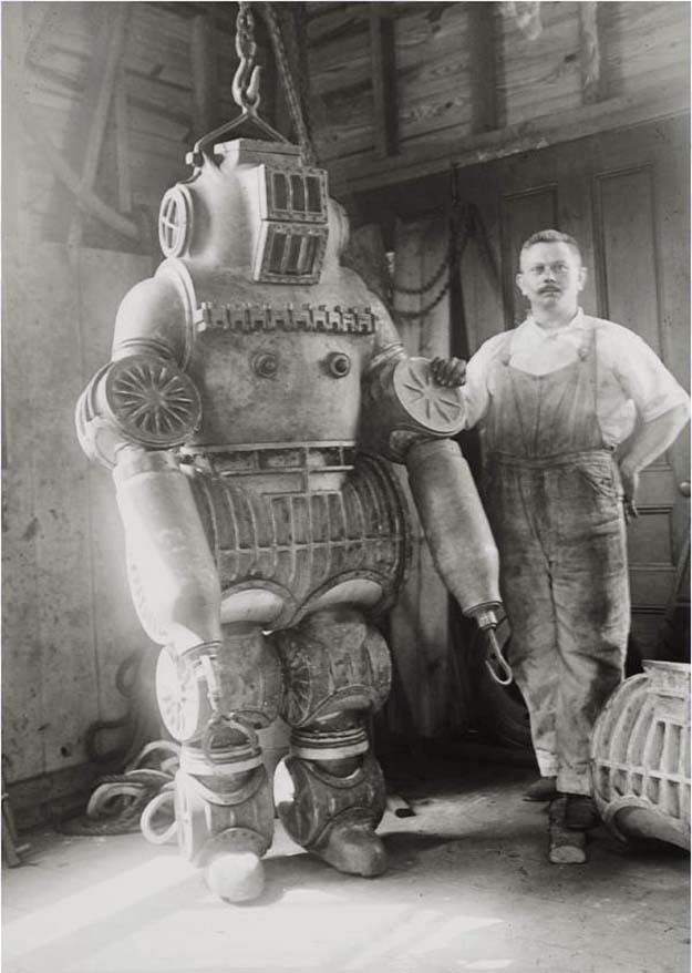 Chester E. Macduffee next to his newly patented, 250 kilo ping suit, 1911