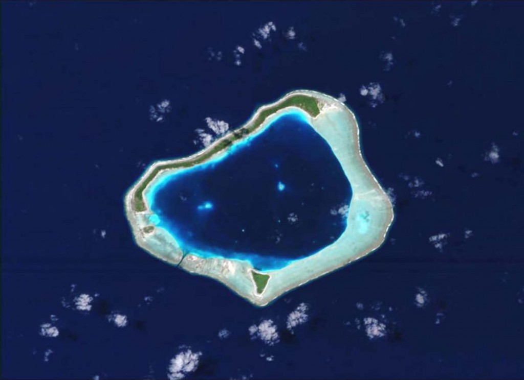  typical atoll belonging to the Society Islands, part of the overseas territory of French Polynesia. The atoll is made of a deep central lagoon surrounded by submerged reefs