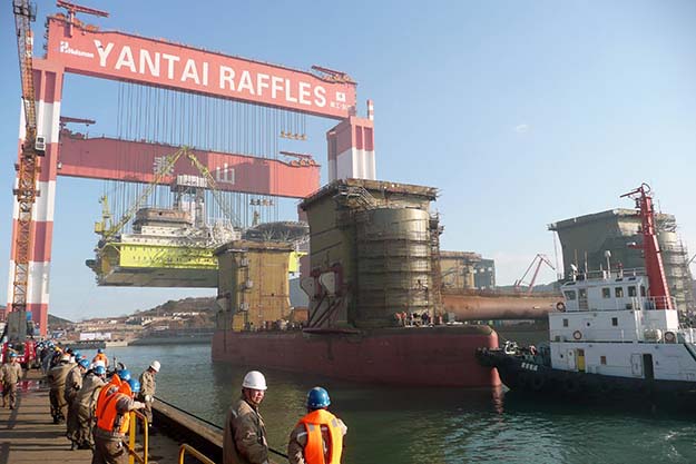 Taisun, the world’s strongest crane, preparing to lower an oil platform onto its pontoons, Yantai, China