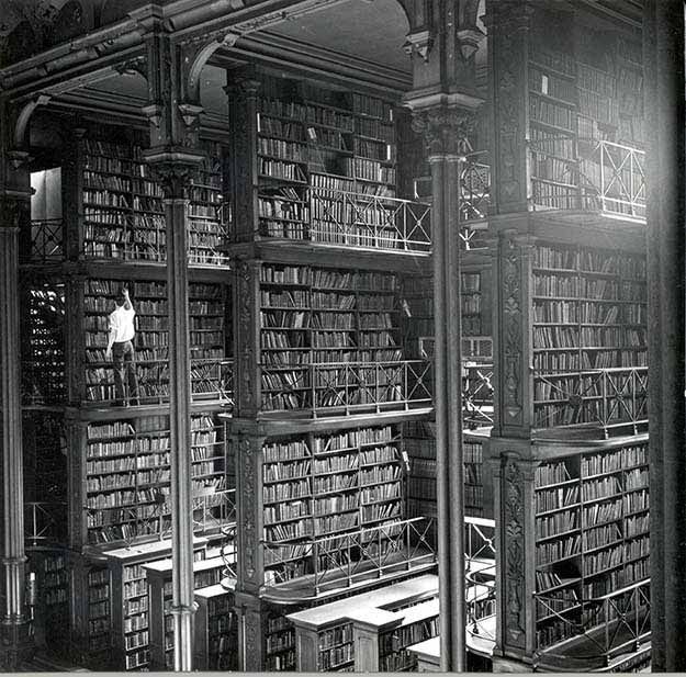 A man browsing for books in Cincinnati’s cavernous old main library. The library was demolished in 1955