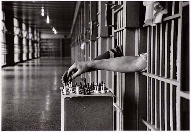 Inmates playing chess from their prison cells, by Cornell Capa, 1972