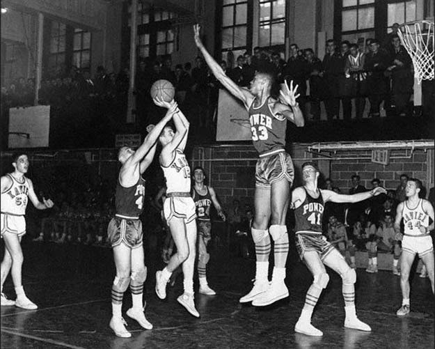 Lew Alcindor blocking a shot during a high school basketball game. 1964