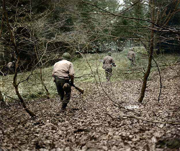 American G.I.’s from the First Army hunt German paratroopers dropped during the Battle of the Bulge somwhere in Belgium, Dec. 18, 1944